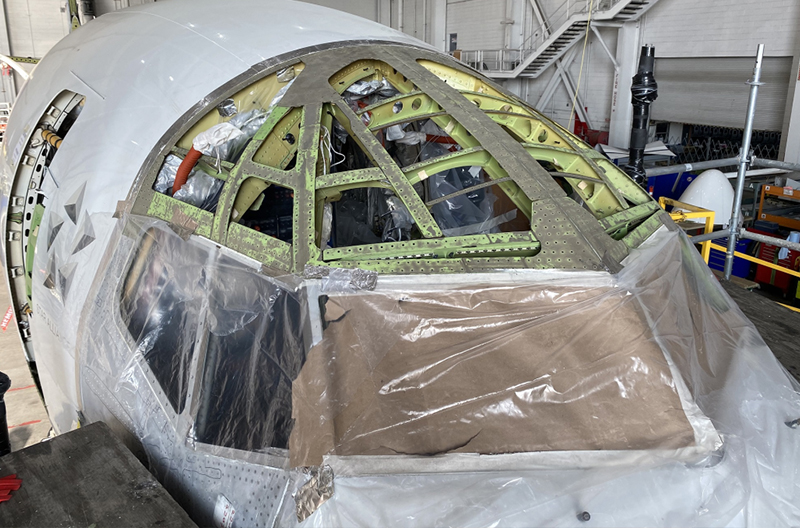 Aircraft exterior exposed in workshop.