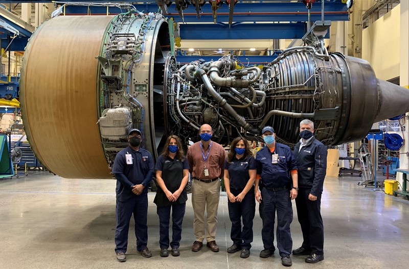 SFO Engine Shop technicians stand in front of a PW4090 engine